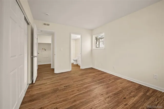 a view of a room with wooden floor