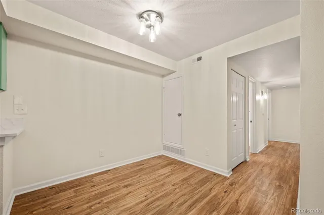 a view of a room with wooden floor