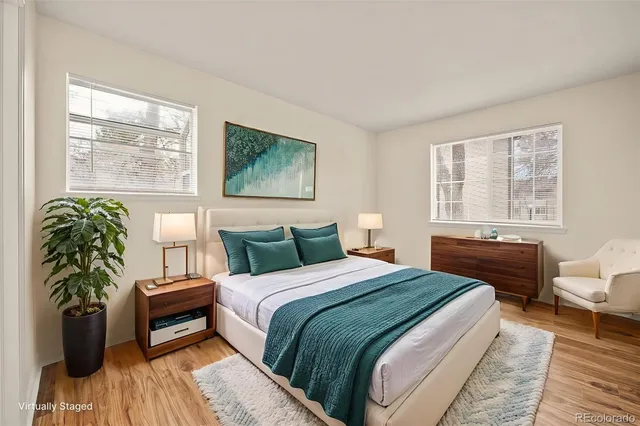 a bedroom with a bed and a potted plant