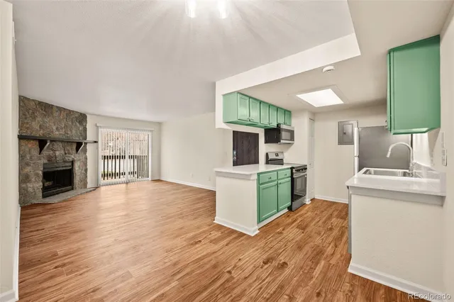 a view of a kitchen with furniture and wooden floor
