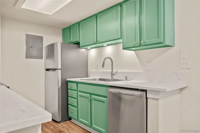 a kitchen with a sink and a refrigerator