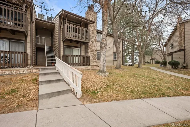 a front view of a house with a tree