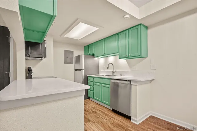 a kitchen with kitchen island a sink stove and refrigerator