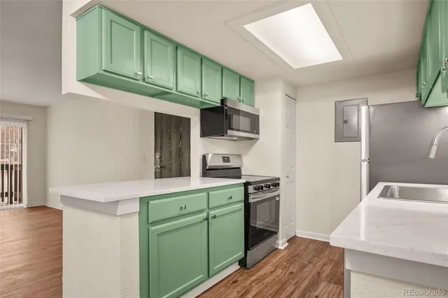 a kitchen with stainless steel appliances white cabinets and a stove top oven