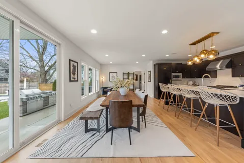 a kitchen that has a lot of cabinets a sink and a wooden floor
