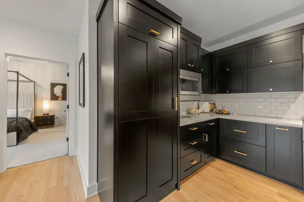 a bathroom with a granite countertop sink a toilet and a mirror