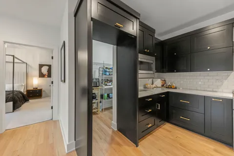 a bathroom with a granite countertop sink a toilet and a mirror