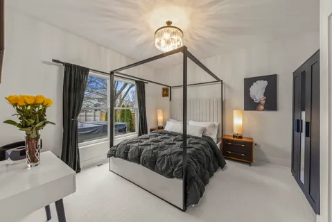 a bedroom with a bed and a television