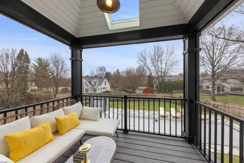 a living room with furniture a flat screen tv and a large window