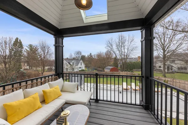 a living room with furniture a flat screen tv and a large window