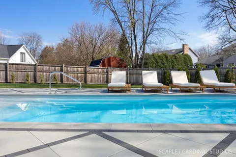 a view of a wooden house with a tree in front