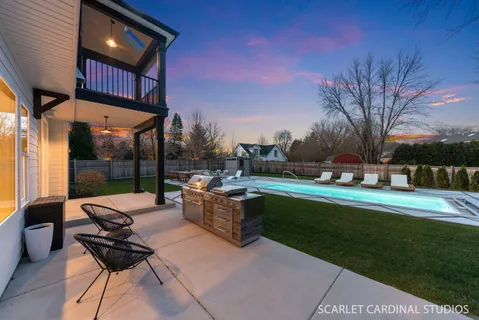 a view of a patio with couches and table and chairs and potted plants