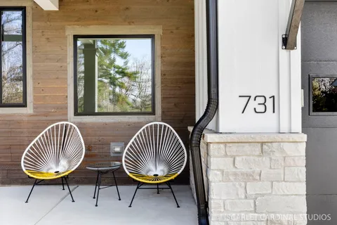 a view of a bedroom with wooden floor and a chandelier