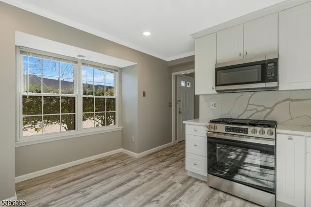 a kitchen with a refrigerator stove and microwave