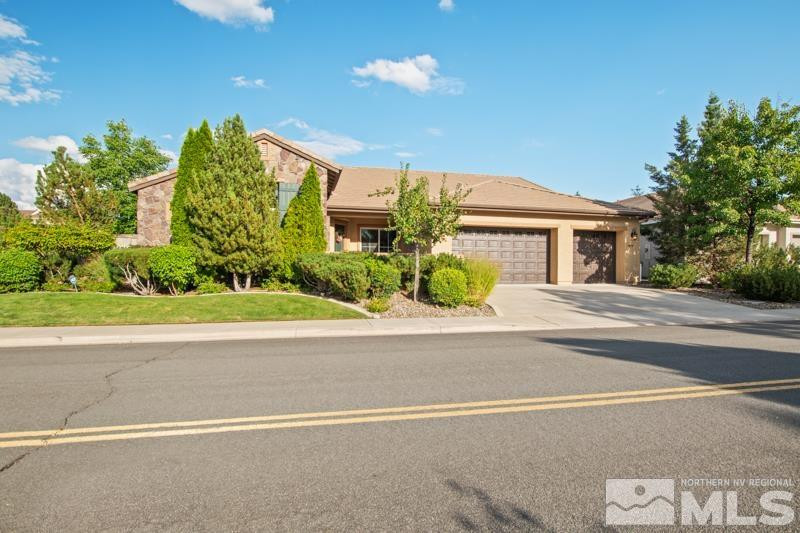 9900 Bridgeview Court Reno, NV 89521 - Photo 1 of 31 a front view of a house with a yard and a garage
