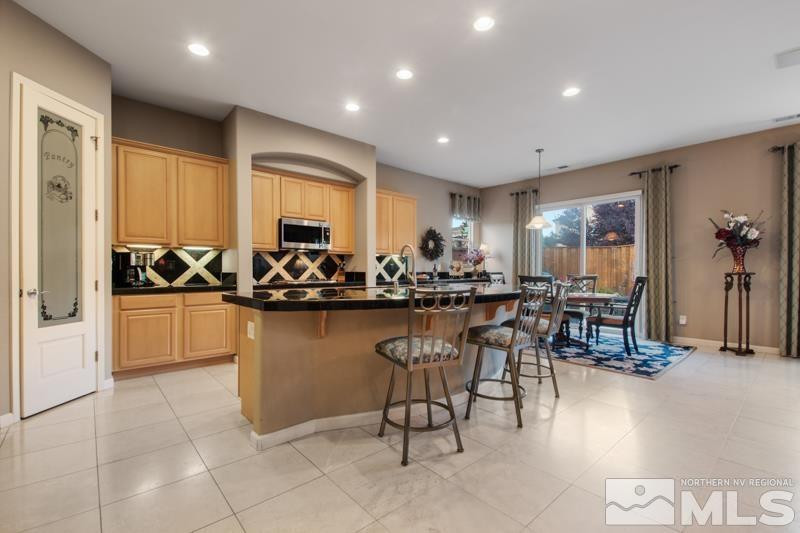 9900 Bridgeview Court Reno, NV 89521 - Photo 11 of 31 a kitchen with counter and chairs