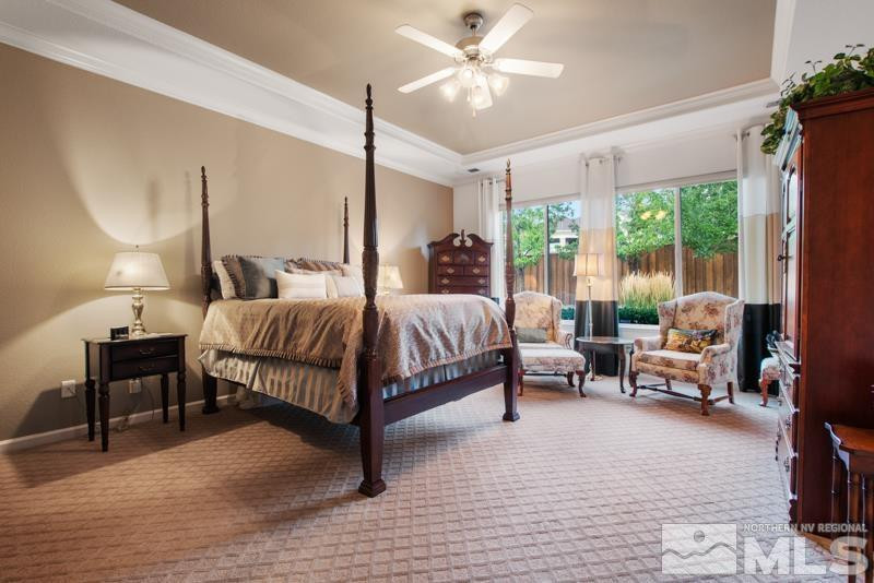 9900 Bridgeview Court Reno, NV 89521 - Photo 19 of 31 a bedroom with a bed couch chandelier and a large window