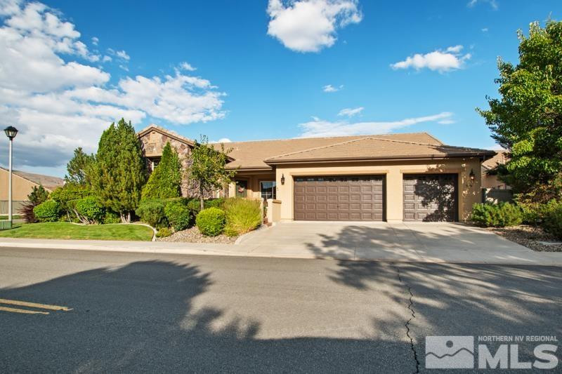 9900 Bridgeview Court Reno, NV 89521 - Photo 2 of 31 a front view of a house with a yard and a garage