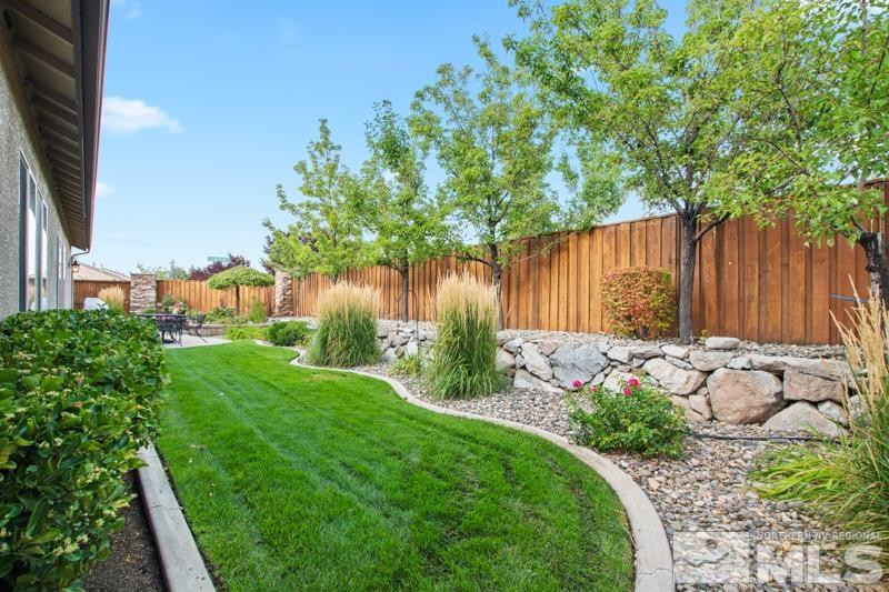 9900 Bridgeview Court Reno, NV 89521 - Photo 29 of 31 a view of a backyard with plants and a lake view