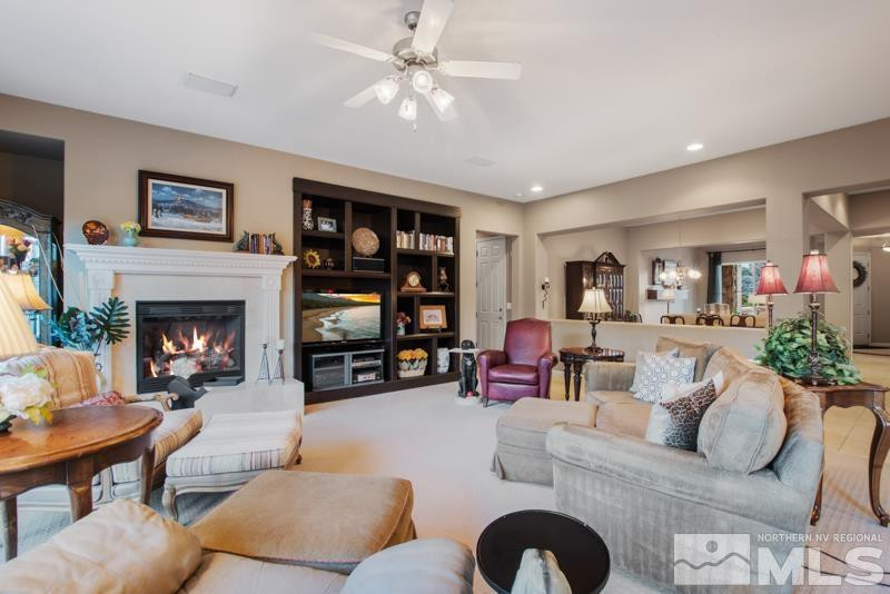 9900 Bridgeview Court Reno, NV 89521 - Photo 9 of 31 a living room with furniture and a fireplace