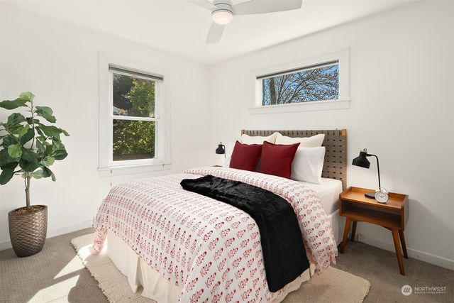 a bedroom with a bed and a potted plant