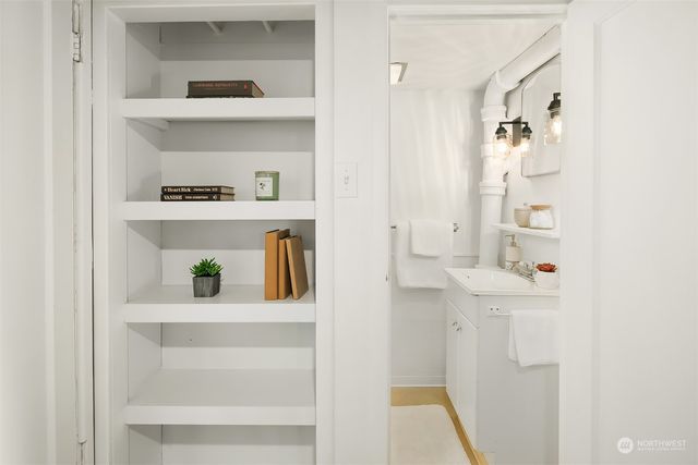a view of kitchen cabinets with wooden floor