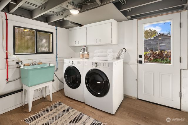 a utility room with sink dryer and washer