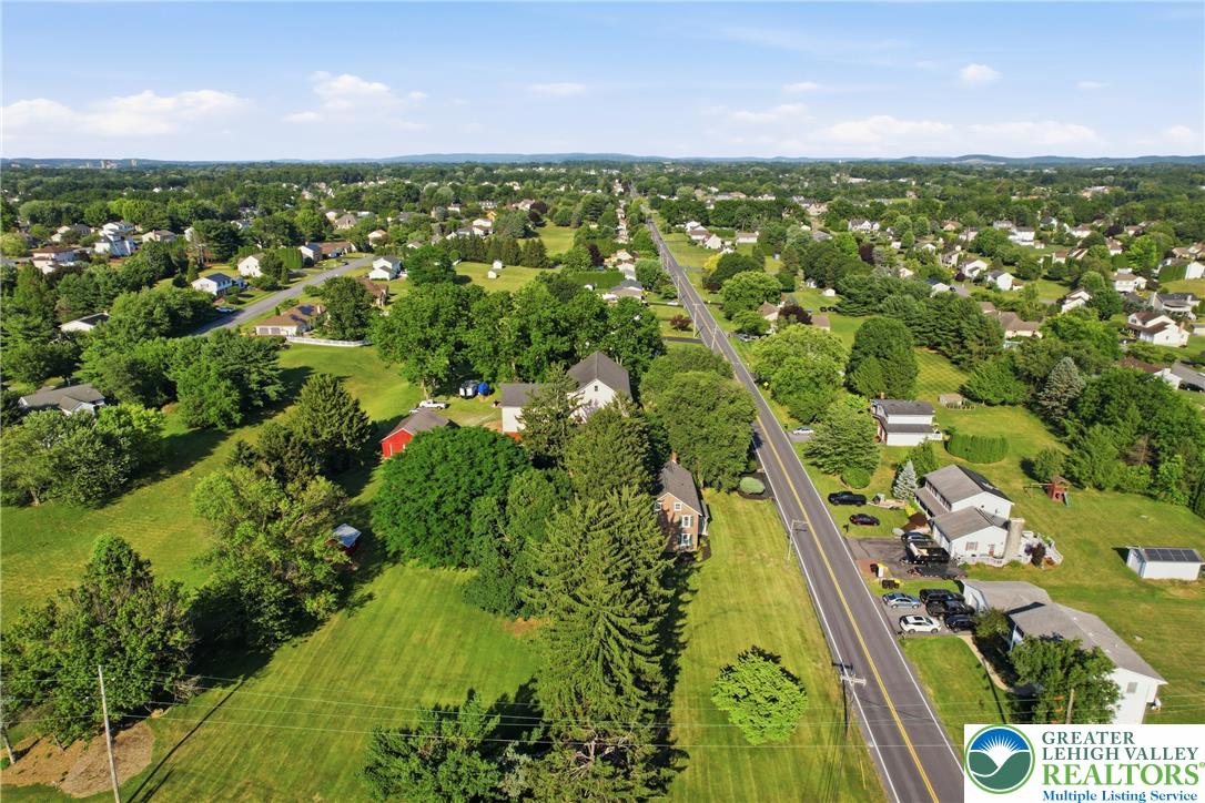 4682 Steuben Road Bethlehem, PA 18020 - Photo 69 of 79 An aerial perspective reveals a tree-lined neighborhood alongside a serene, rural landscape.