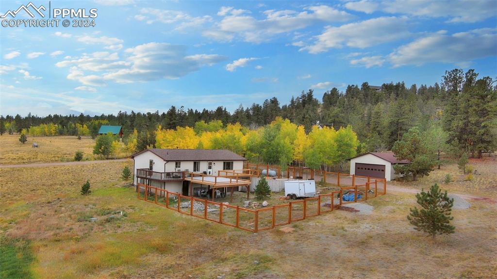 899 Concho Trail Hartsel, CO 80449 - Photo 5 of 27 a view of a lake with a garden and deck
