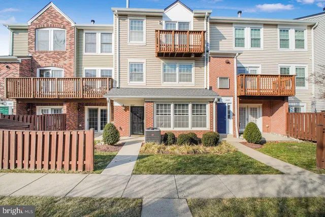 a front view of a residential apartment building with a yard