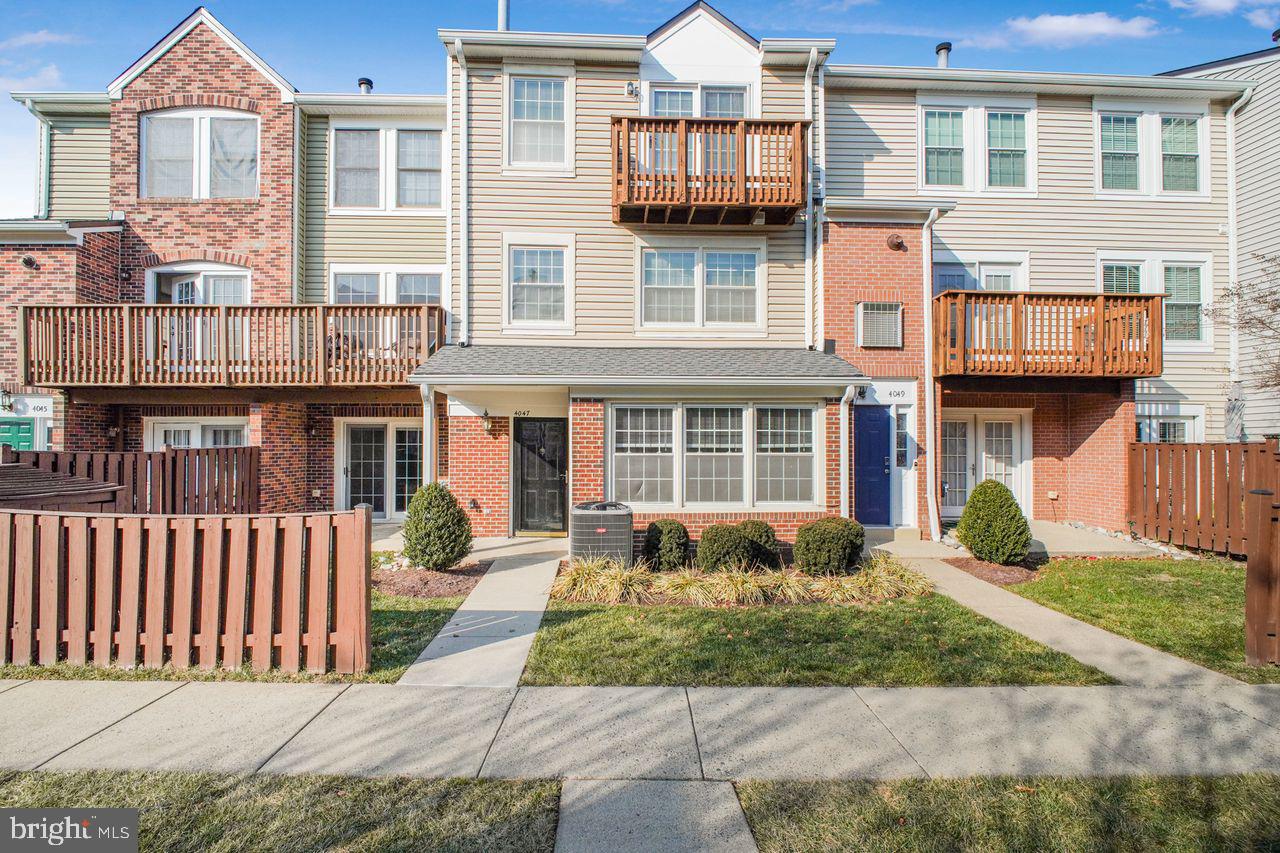 4047 Chetham Way Woodbridge, VA 22192 - Photo 1 of 55 a front view of a residential apartment building with a yard
