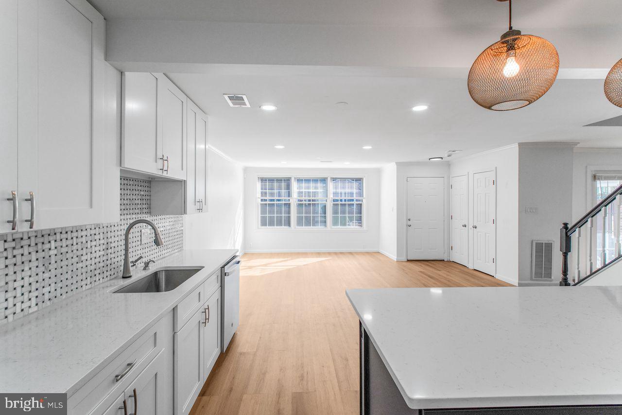 4047 Chetham Way Woodbridge, VA 22192 - Photo 12 of 55 a kitchen with stainless steel appliances granite countertop a sink a stove and a wooden floors