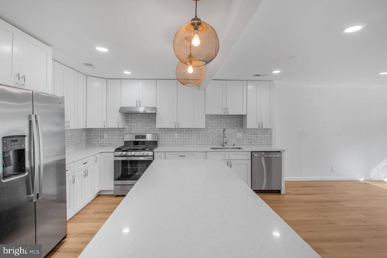 4047 Chetham Way Woodbridge, VA 22192 - Photo 14 of 55 a kitchen with a sink stainless steel appliances and cabinets