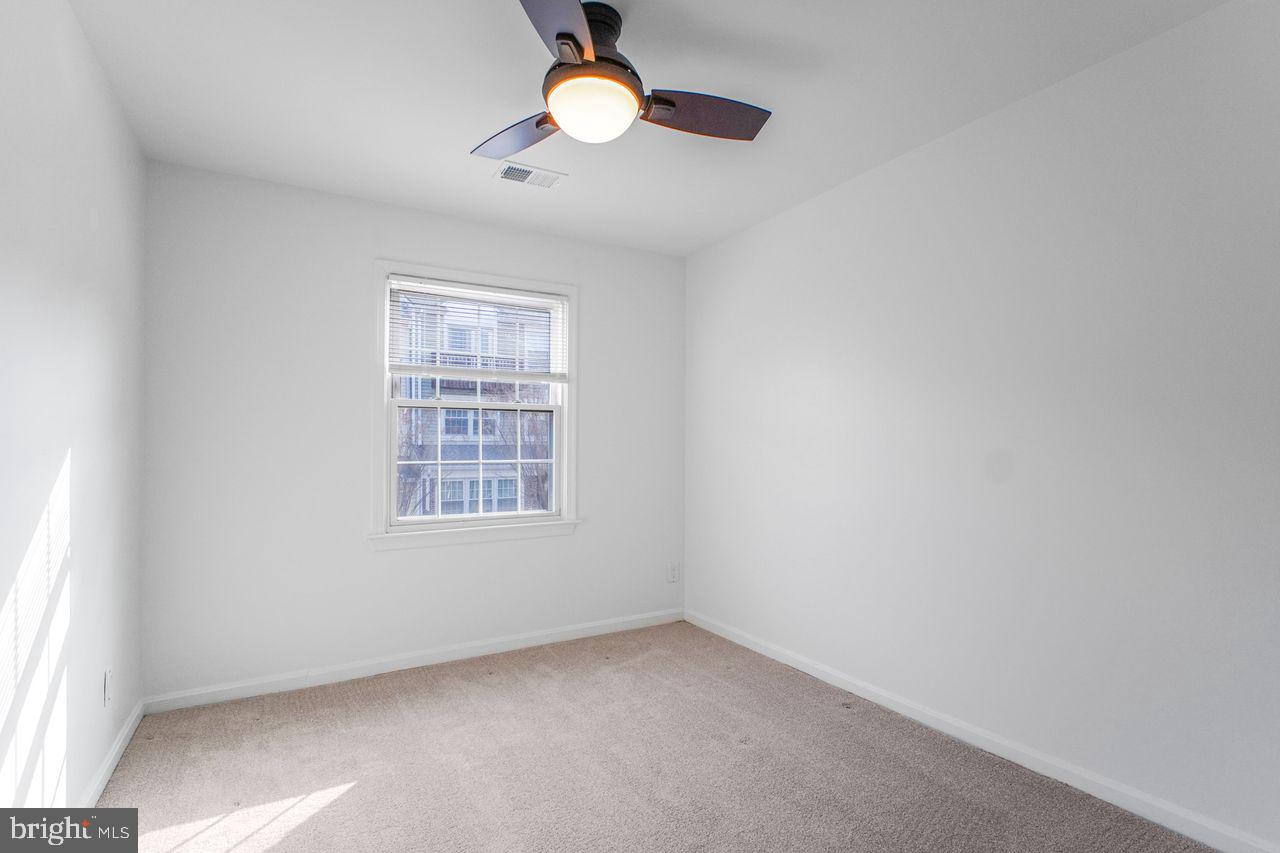 4047 Chetham Way Woodbridge, VA 22192 - Photo 24 of 55 an empty room with a window and a fan
