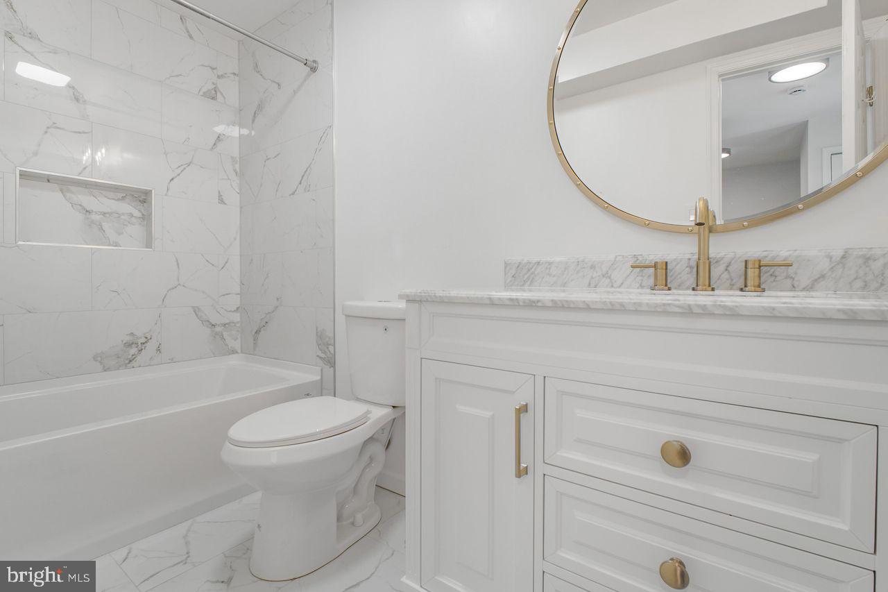 4047 Chetham Way Woodbridge, VA 22192 - Photo 27 of 55 a bathroom with a sink a toilet and a mirror