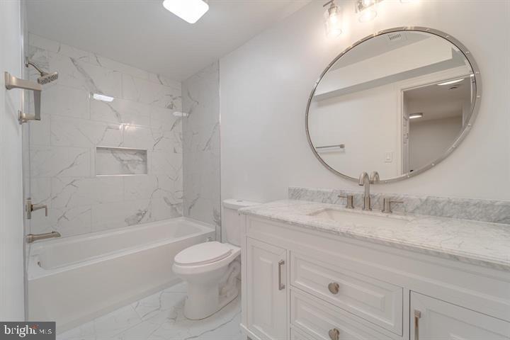4047 Chetham Way Woodbridge, VA 22192 - Photo 28 of 55 a bathroom with a granite countertop sink a toilet and a mirror