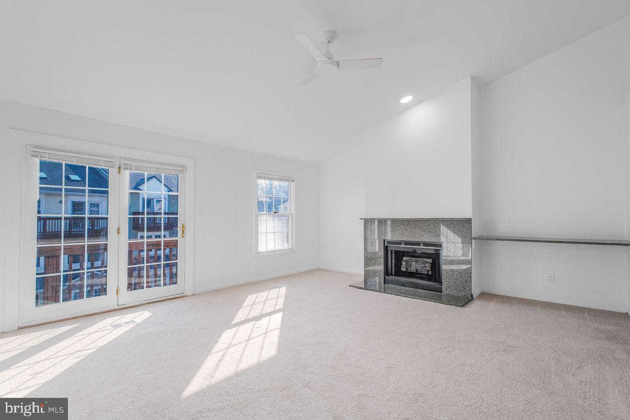 4047 Chetham Way Woodbridge, VA 22192 - Photo 34 of 55 an empty room with furniture and a fireplace