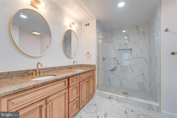 4047 Chetham Way Woodbridge, VA 22192 - Photo 40 of 55 a bathroom with a double vanity sink mirror and shower