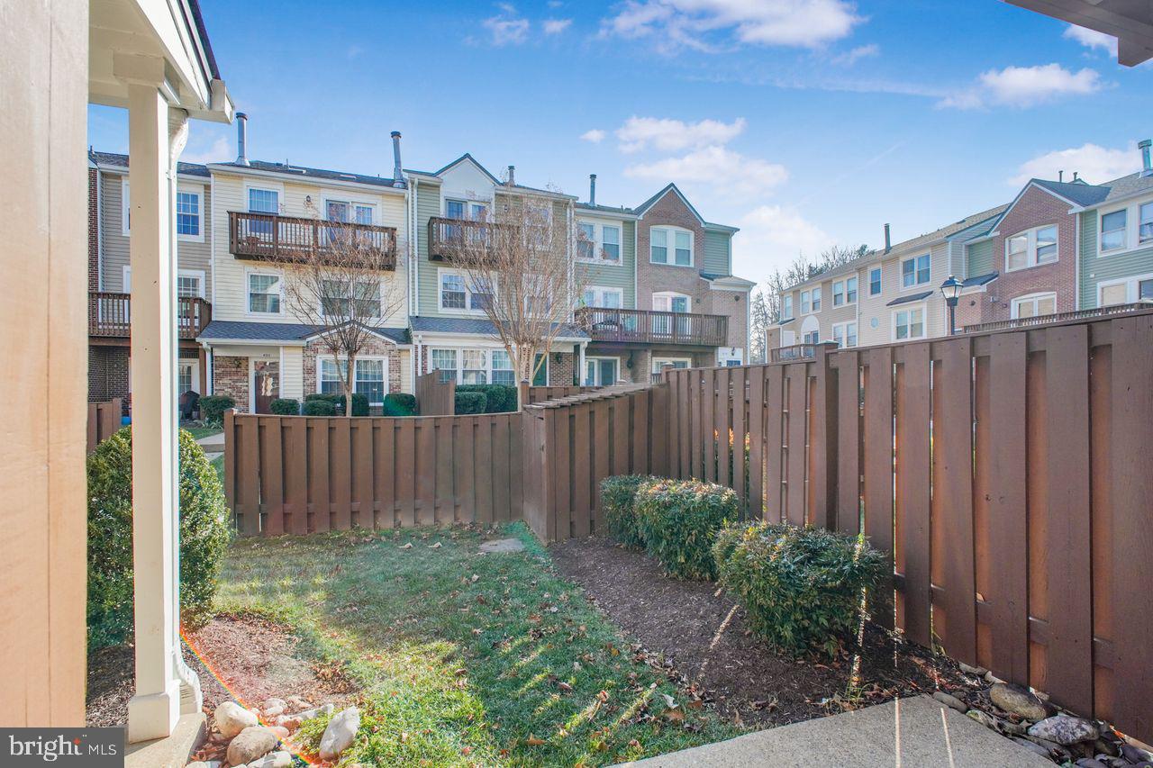 4047 Chetham Way Woodbridge, VA 22192 - Photo 8 of 55 a view of a brick house next to a yard