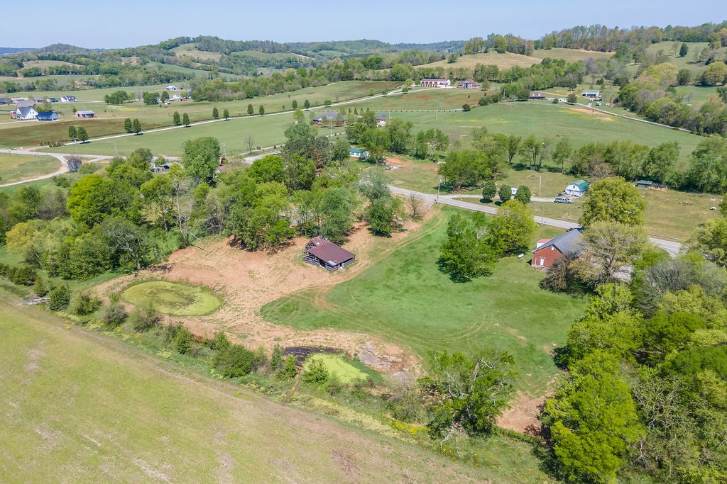 3938 Ostella Road Cornersville, TN 37047 - Photo 15 of 17 an aerial view of green landscape with trees houses and mountain view