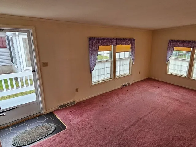 en empty room with windows and entryway