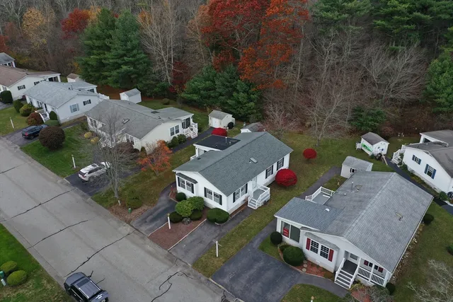 a aerial view of a house with yard and outdoor seating