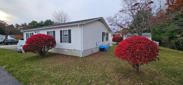 a view of a house with a backyard and garden