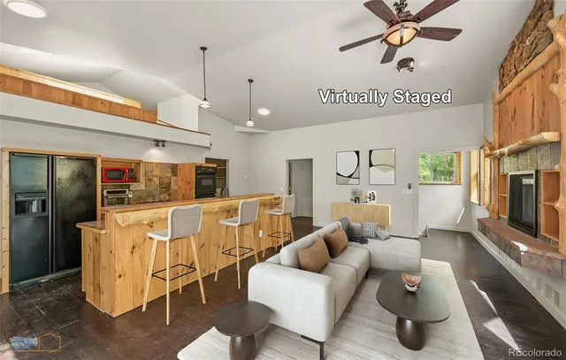 a view of an empty room with wooden floor fireplace and a window