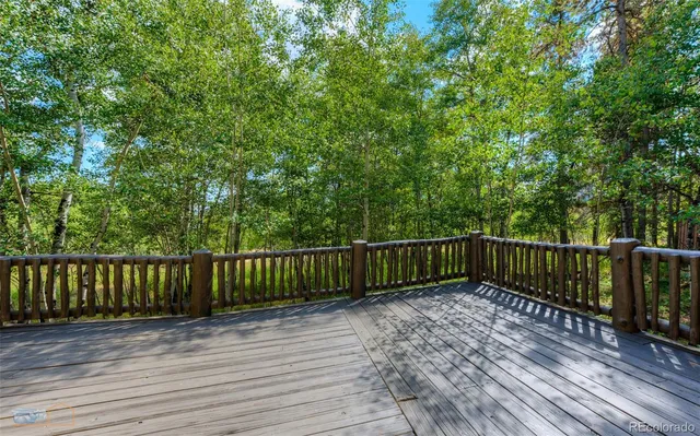 a view of a porch with wooden floor and fence