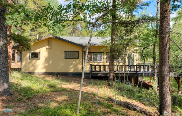 a backyard of a house with large trees