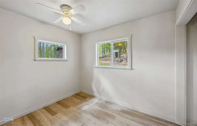 a bathroom with a toilet a sink and a mirror