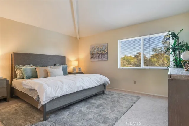 a bedroom with a bed lamp and window