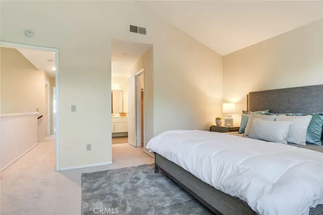 a bedroom with a bed and a painting