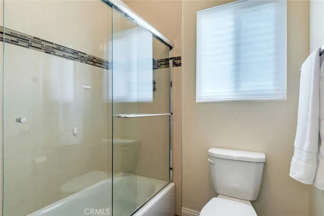 a bathroom with a toilet shower and a bathtub
